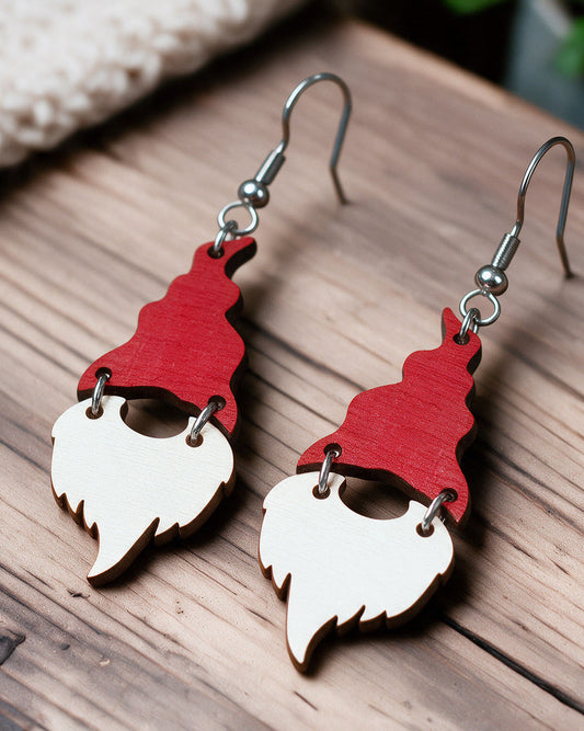 Christmas elf earrings made in Finland, photographed on a wooden table in natural light