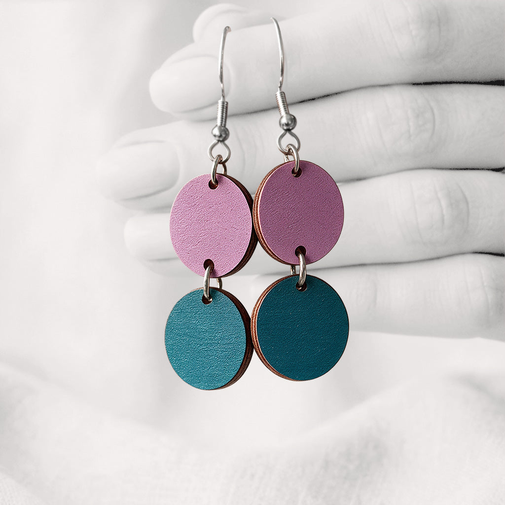 Heather and petrolblue Tuplakupla duo plywood earrings handmade in Finland, featuring two round wooden pieces on stainless steel hooks