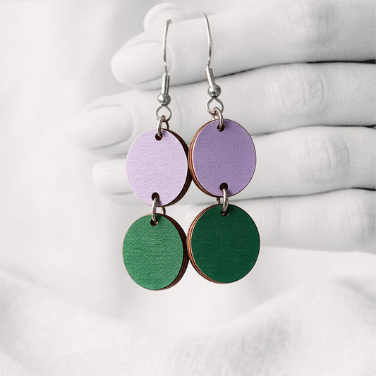 Purple and green Tuplakupla duo plywood earrings handmade in Finland, featuring two round wooden pieces on stainless steel hooks