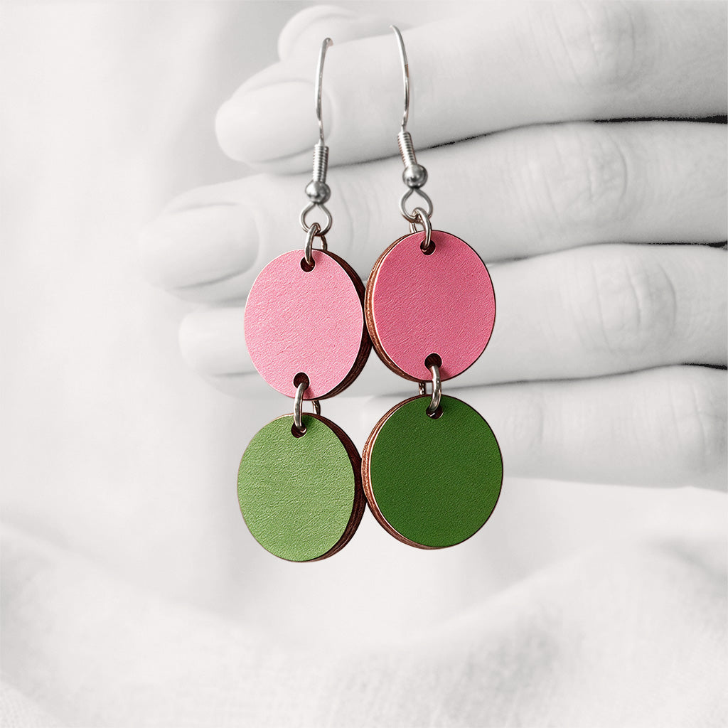 Blush and green Tuplakupla duo plywood earrings handmade in Finland, featuring two round wooden pieces on stainless steel hooks