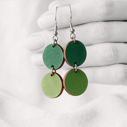 Green Tuplakupla duo plywood earrings handmade in Finland, featuring two round wooden pieces on stainless steel hooks