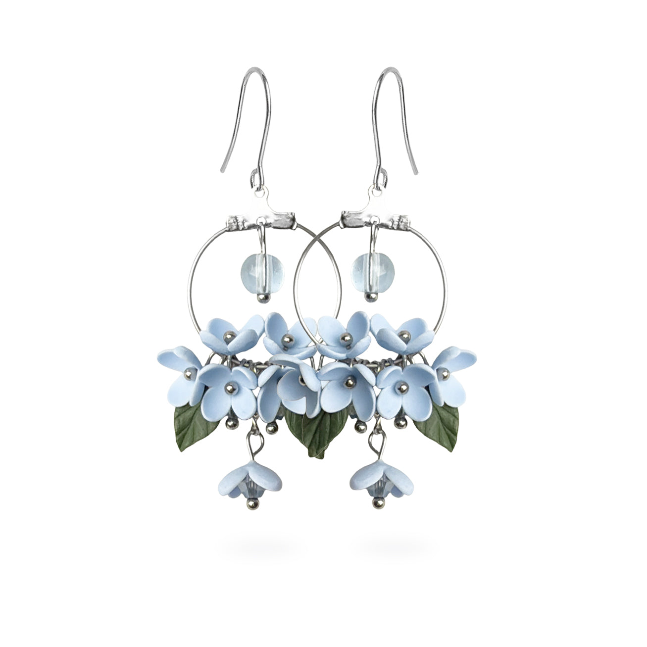 Mist Flower Hoop Earrings featuring delicate pale blue flowers, green leaves, and sparkling crystal details. Handmade in Finland by byMinta.