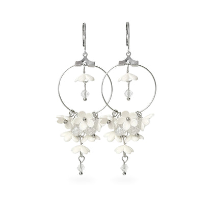 White Lilac Hoop Earrings featuring delicate white flowers, crystal details, and an airy silver hoop design. Handmade in Finland by byMinta.