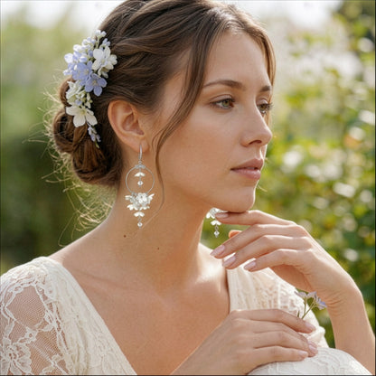 Woman wearing White Lilac Hoop Earrings in a soft summer garden. Handmade floral earrings inspired by the purity and lightness of white lilacs.