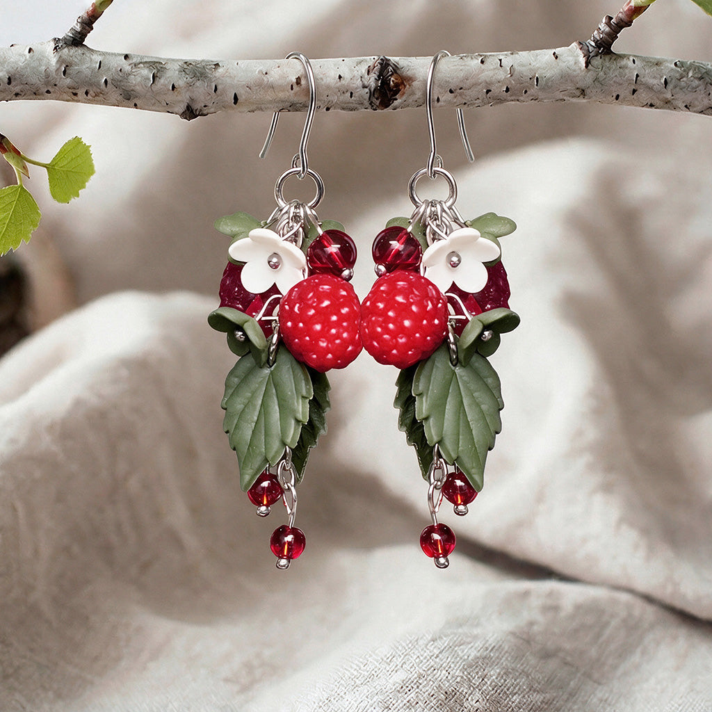 Red Wild Raspberry earrings handmade in Finland, featuring raspberries, white flowers, green leaves and red glass beads on stainless steel hooks